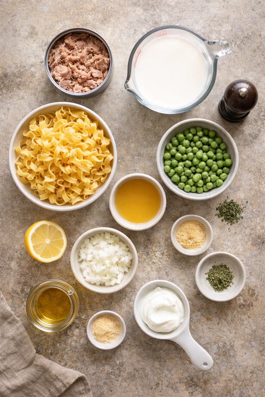 Ingredients for tuna noodle casserole laid out on a surface