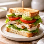 grilled chicken club sandwich with avocado tomato lettuce